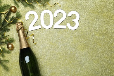 Photo of Happy New Year 2023! Flat lay composition with bottle of sparkling wine on color background, space for text