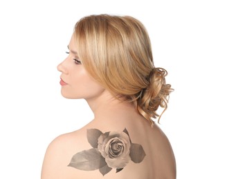 Young woman with beautiful flower tattoo on white background