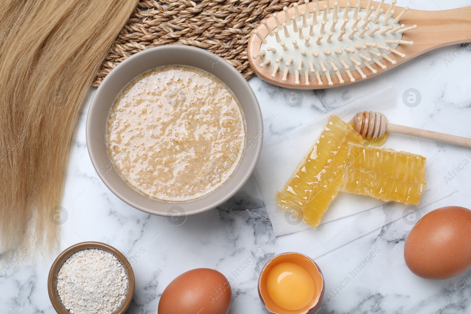 Photo of Flat lay composition with homemade hair mask in bowl on white marble table