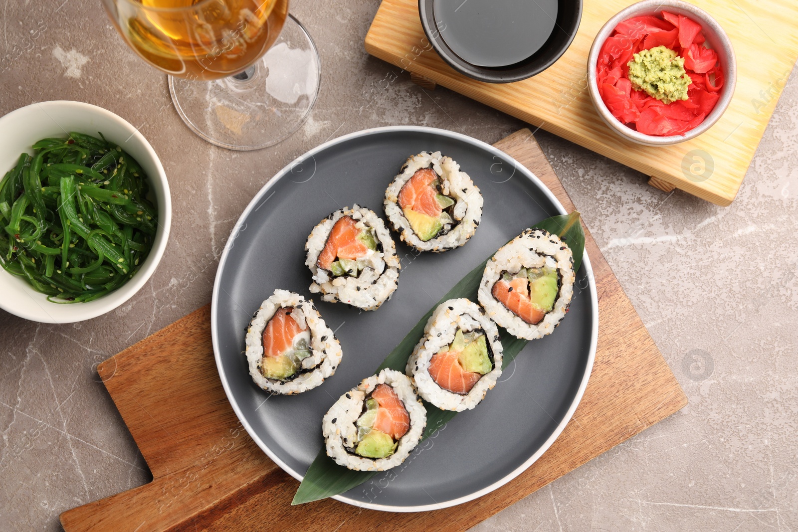 Photo of Flat lay composition with delicious sushi rolls on grey textured table