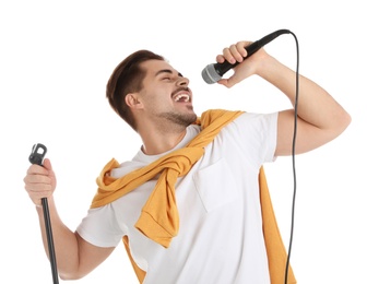 Young handsome man in casual clothes singing with microphone on white background