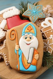 Photo of Tasty gingerbread cookies on table, closeup. St. Nicholas Day celebration