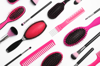 Composition with hair combs and brushes on white background, top view