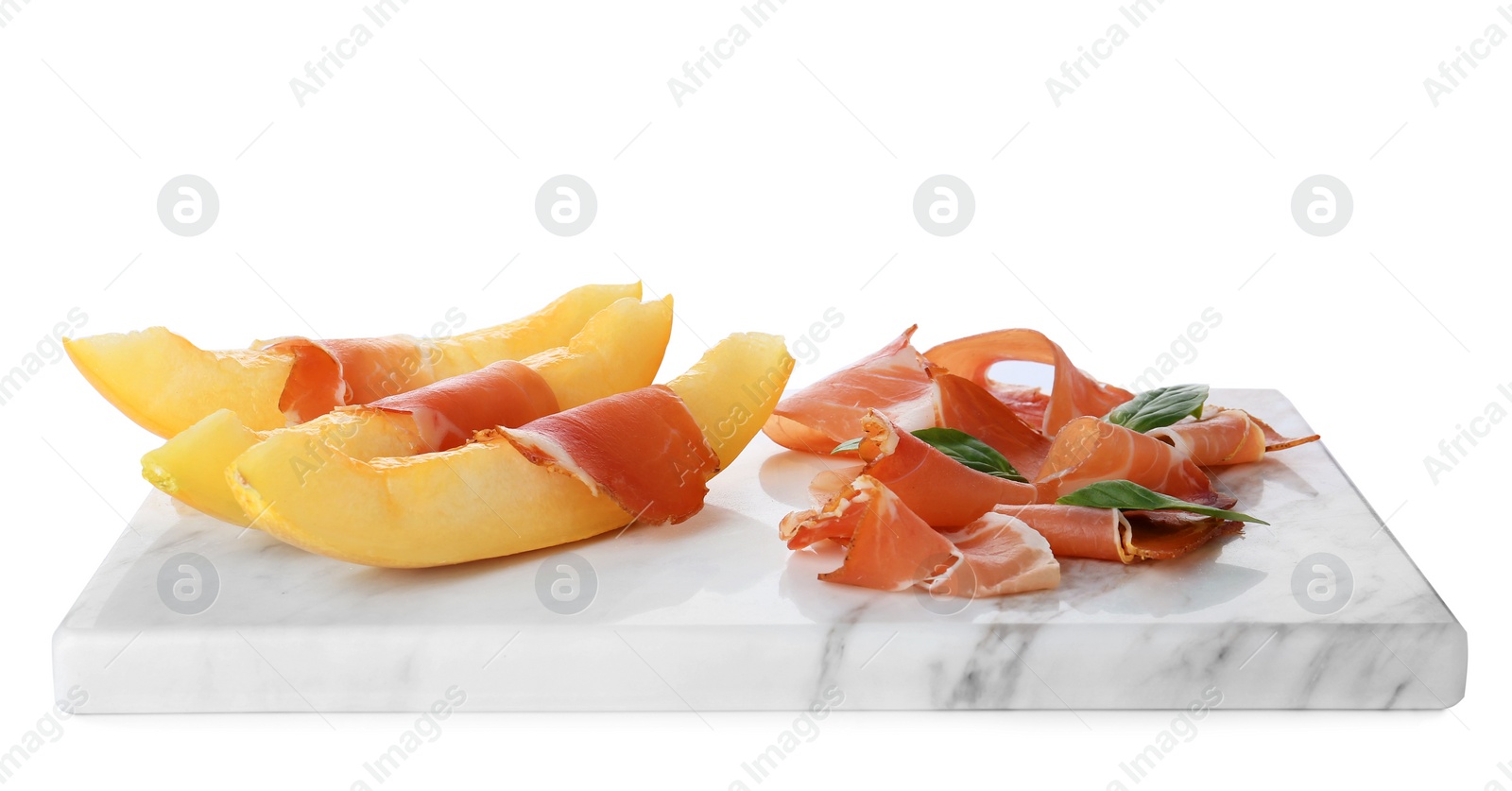 Photo of Board with melon slices and prosciutto on white background