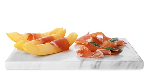 Photo of Board with melon slices and prosciutto on white background