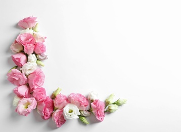 Flat lay composition with beautiful Eustoma flowers on light background