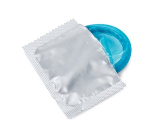 Condom in torn package on white background. Safe sex