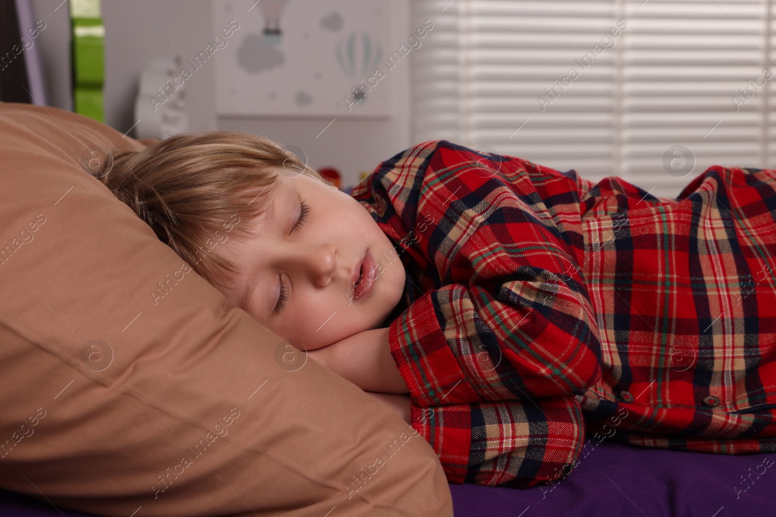 Photo of Little boy snoring while sleeping in bed at home