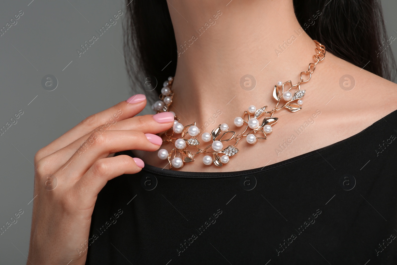 Photo of Woman with elegant necklace on dark grey background, closeup