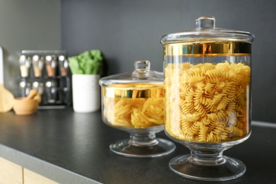 Photo of Products in modern kitchen glass containers on black table