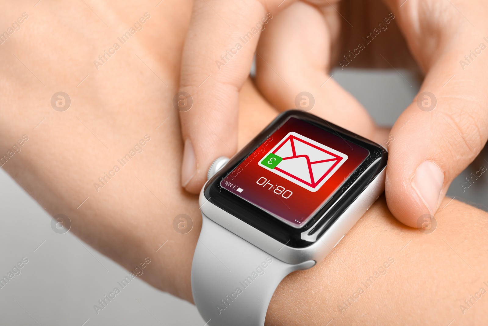 Image of Woman checking mail application in smart watch, closeup