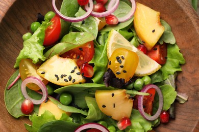 Photo of Delicious salad with peach, green peas and vegetables in bowl, top view