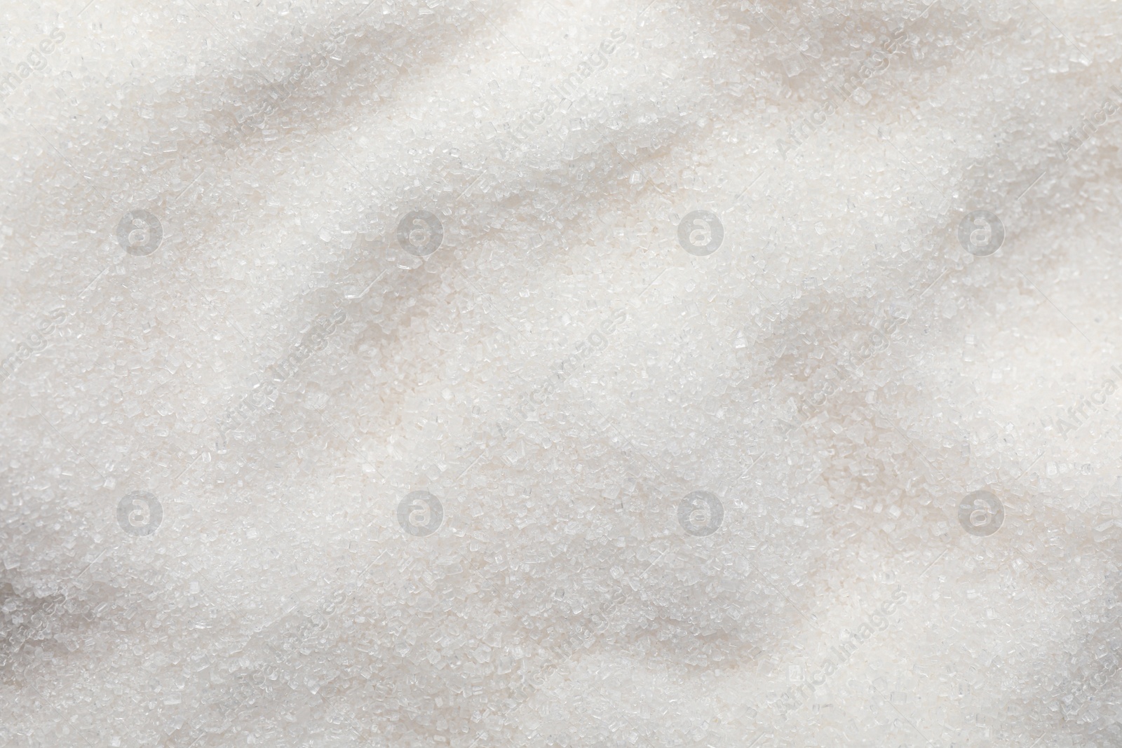 Photo of Sweet granulated sugar as background, top view