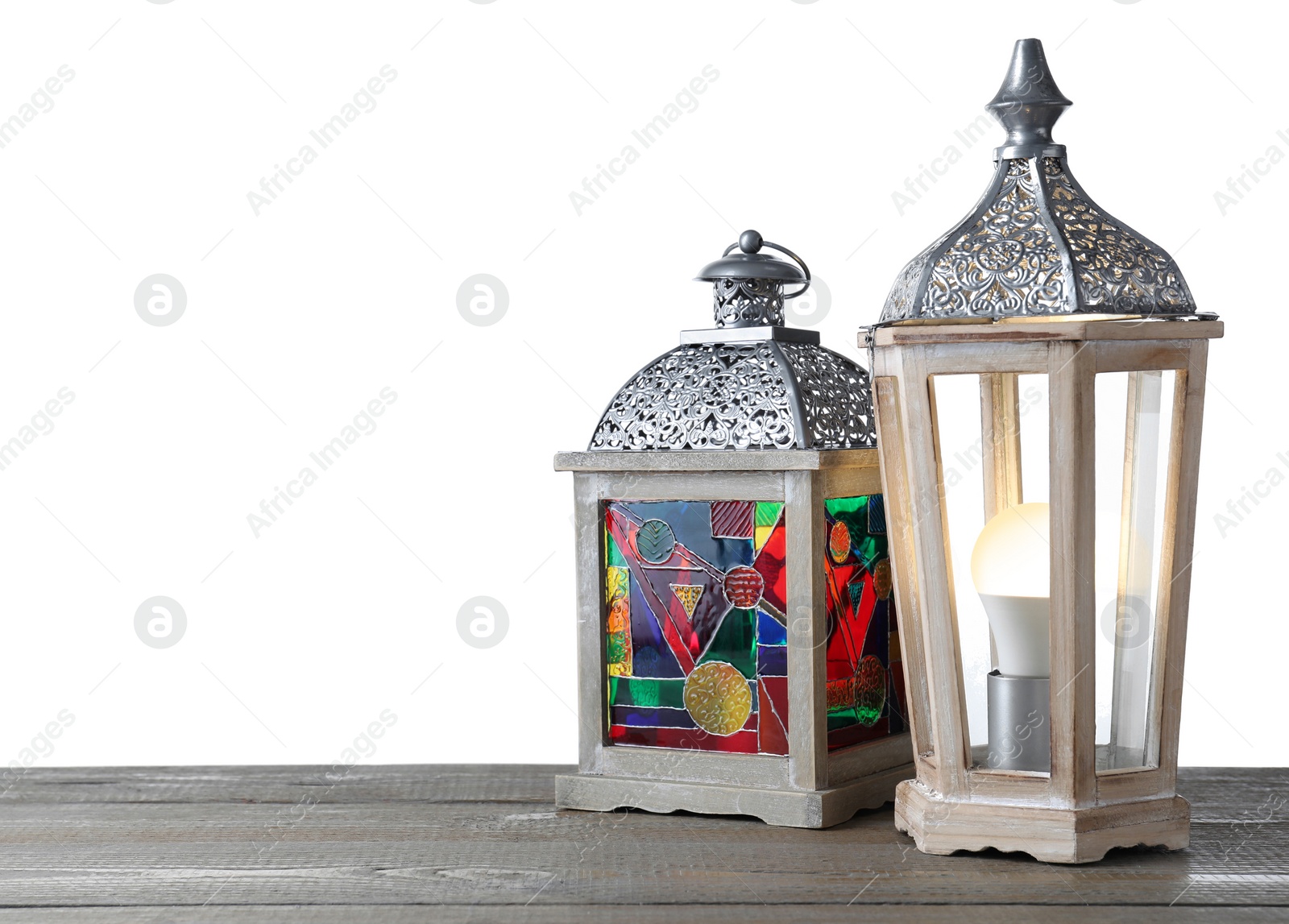 Photo of Decorative Arabic lanterns on wooden table against white background