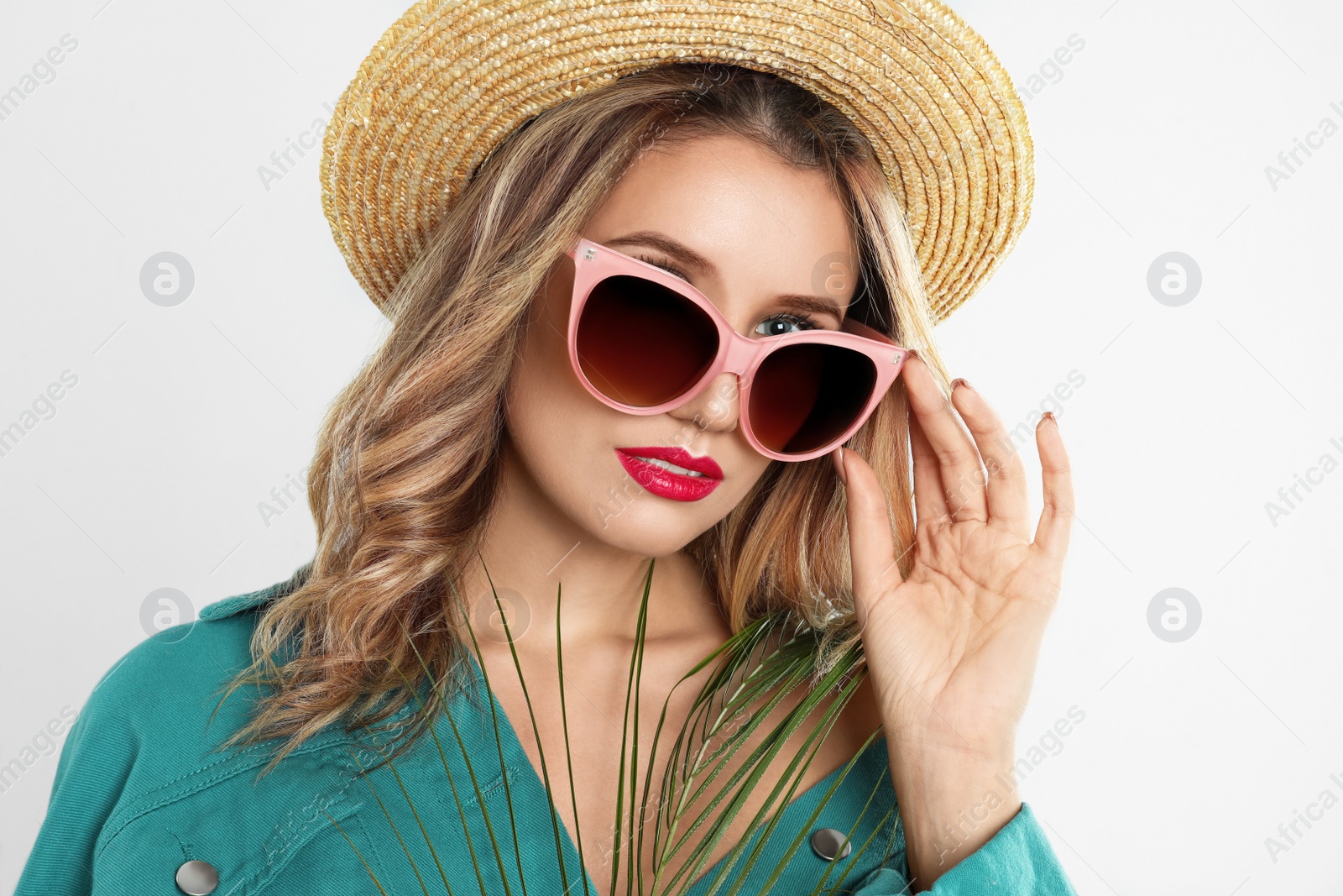 Photo of Young woman wearing stylish sunglasses and hat on grey background