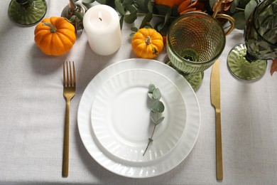 Photo of Beautiful autumn table setting. Plates, cutlery, glasses, pumpkins and floral decor, flat lay