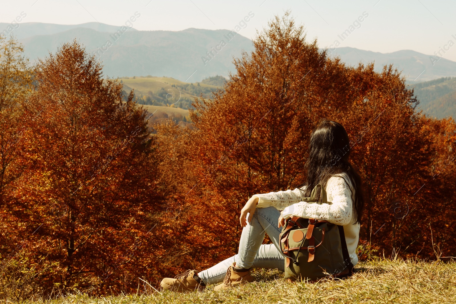 Photo of Woman in warm clothes enjoying mountain landscape