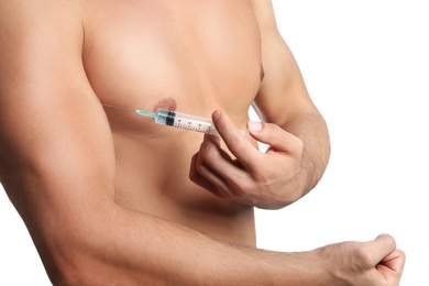 Photo of Athletic man injecting himself on white background, closeup. Doping concept
