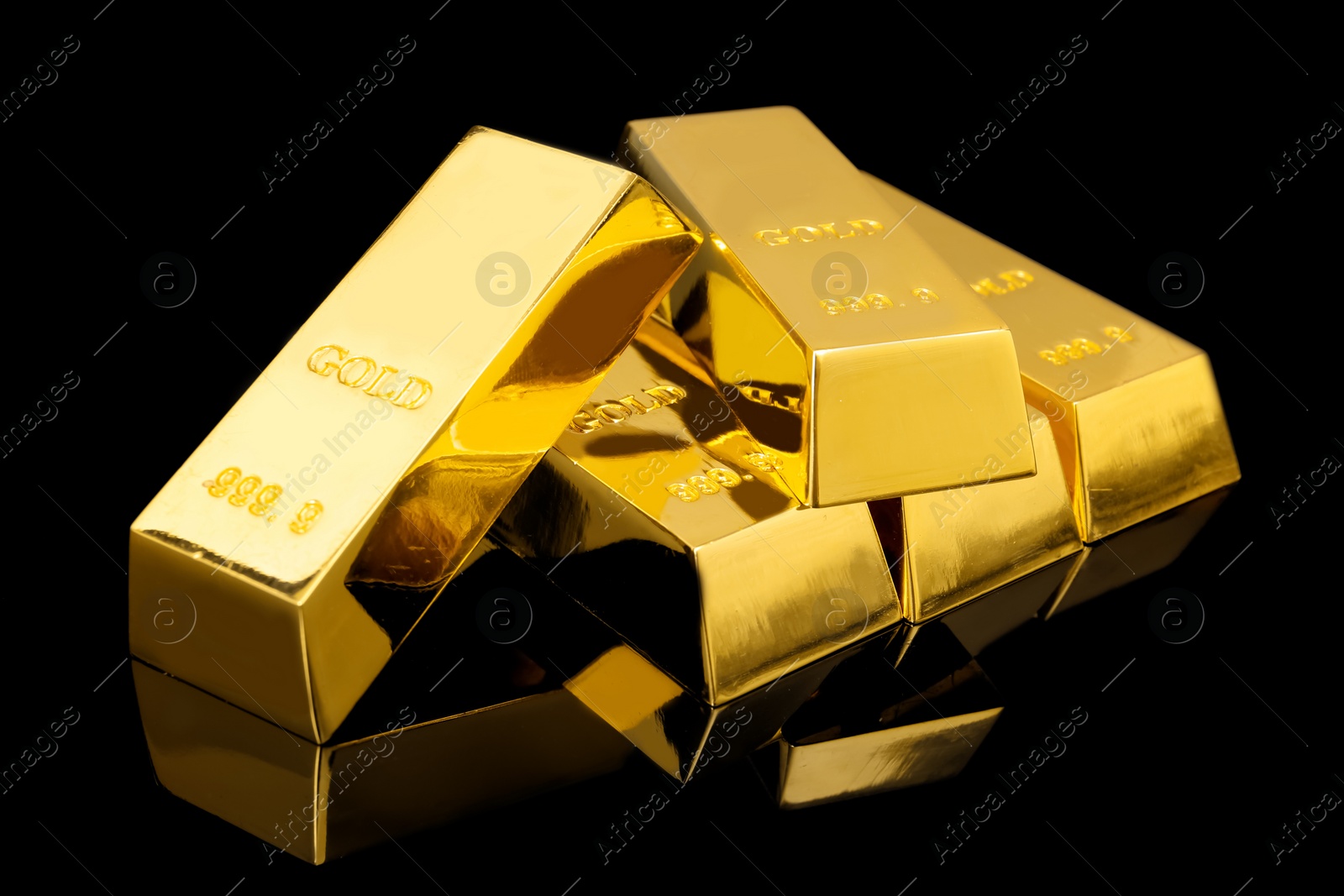 Photo of Many shiny gold bars on black background