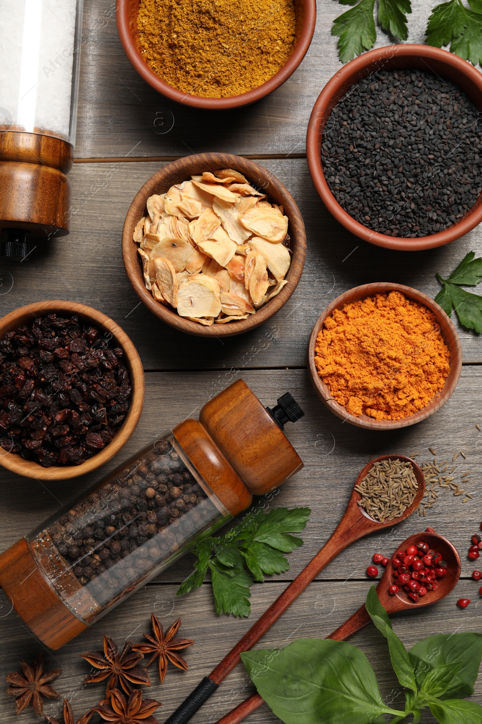 Photo of Flat lay composition with different spices on grey wooden table
