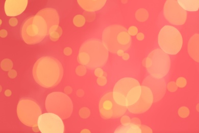 Photo of Beautiful blurred lights on pink background, bokeh effect