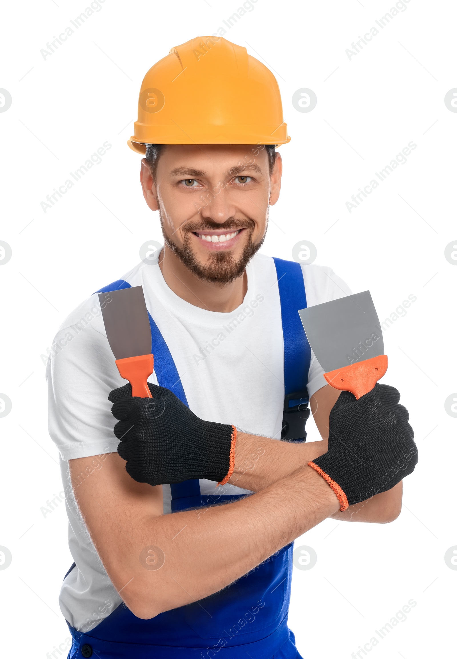 Photo of Professional worker with putty knives in hard hat on white background