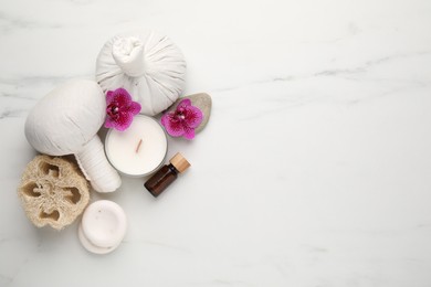 Flat lay composition with different spa products on white marble table. Space for text