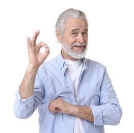 Photo of Portrait of happy grandpa showing ok gesture on white background