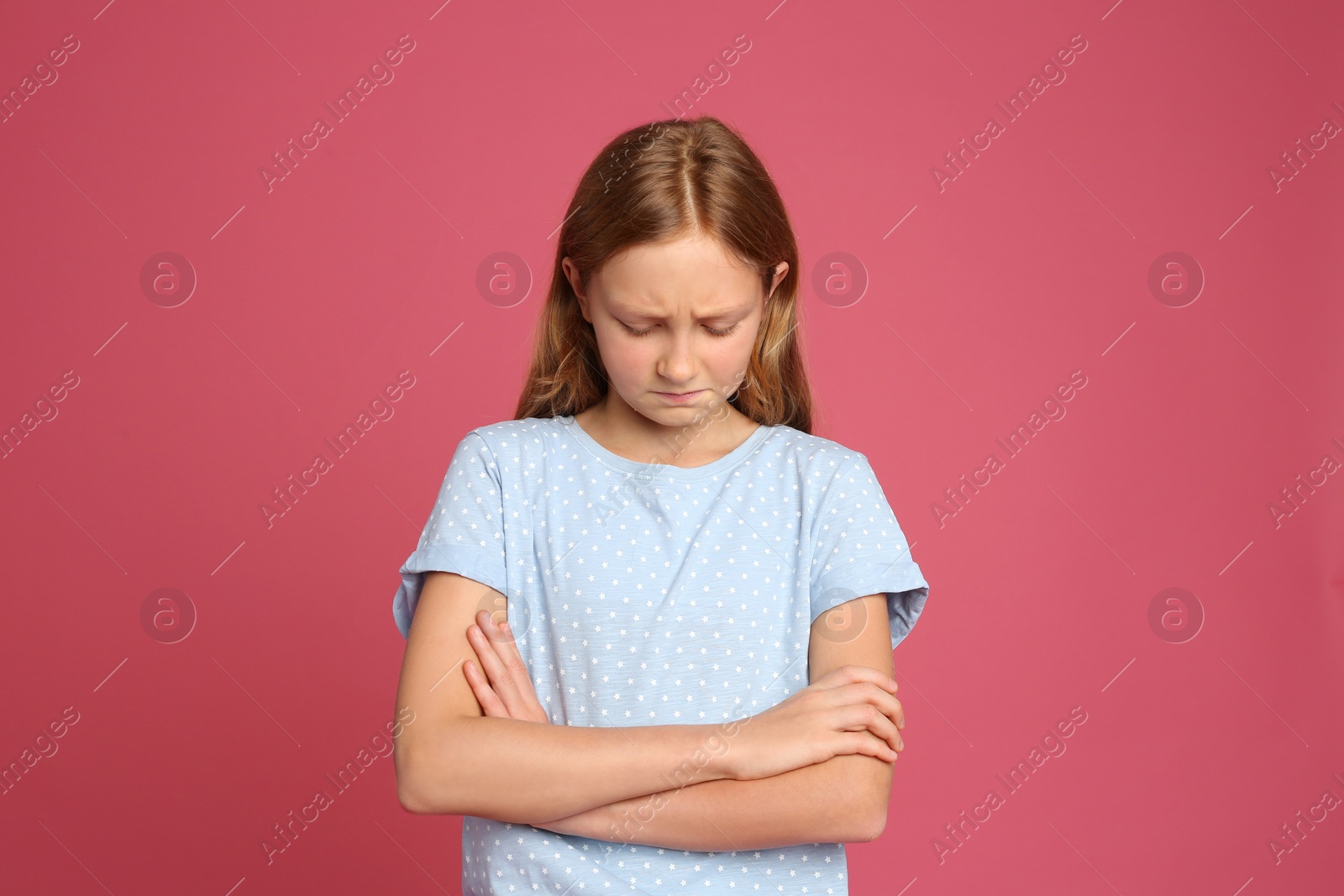 Photo of Portrait of emotional preteen girl on pink background