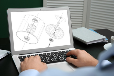 Image of Male engineer working with 3d model of modern equipment on laptop in office, closeup