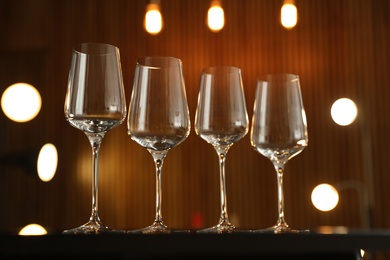 Empty wine glasses on table against blurred background