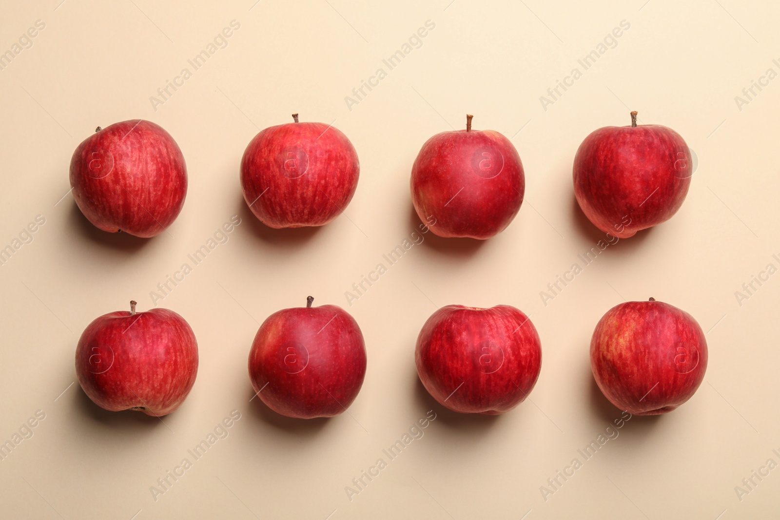 Photo of Fresh red apples on beige background, flat lay