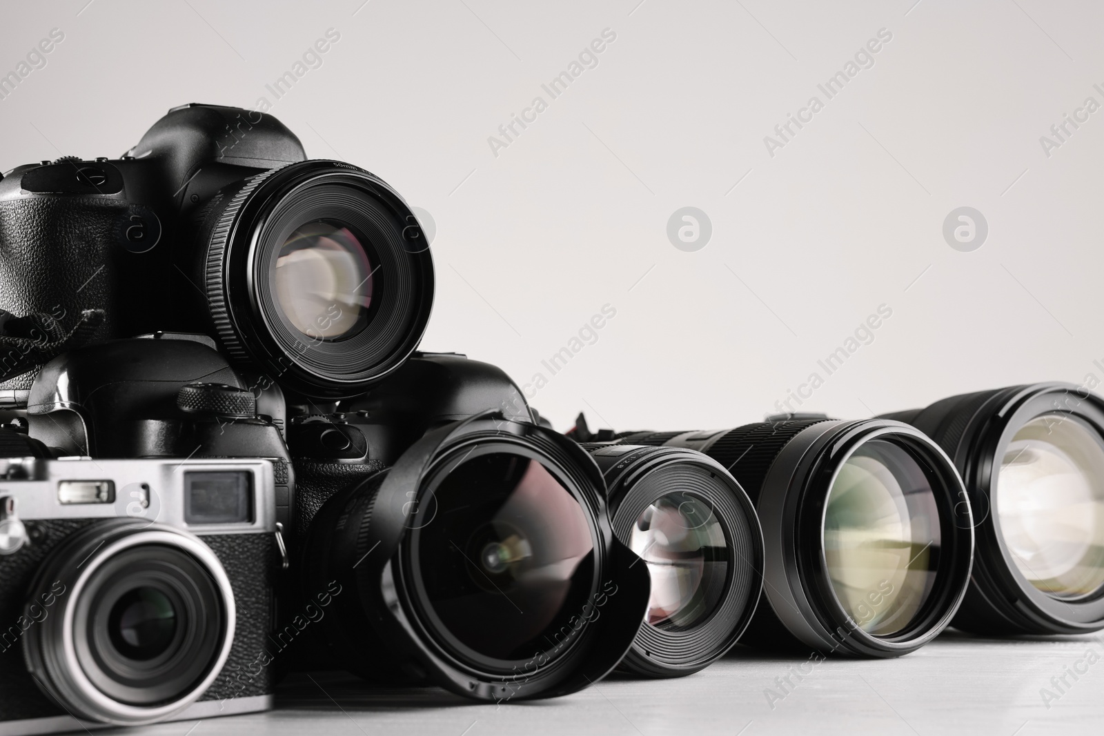 Photo of Modern cameras on white background, space for text