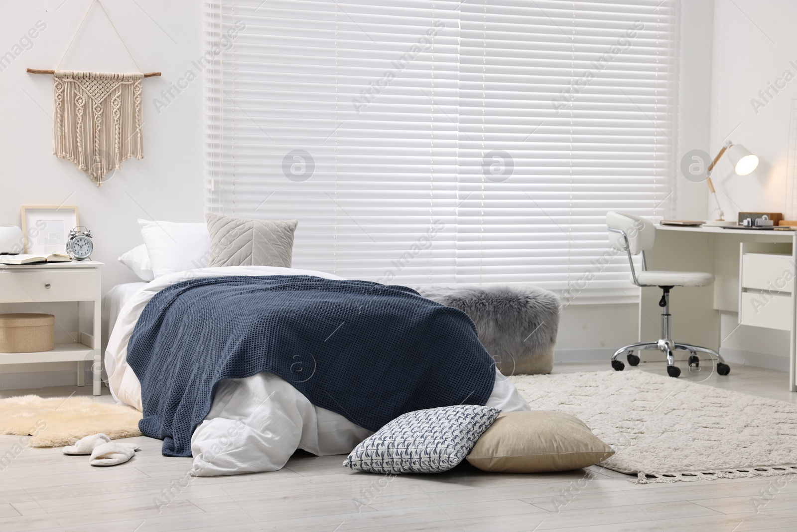 Photo of Bedroom interior with comfortable furniture, big window and white blinds