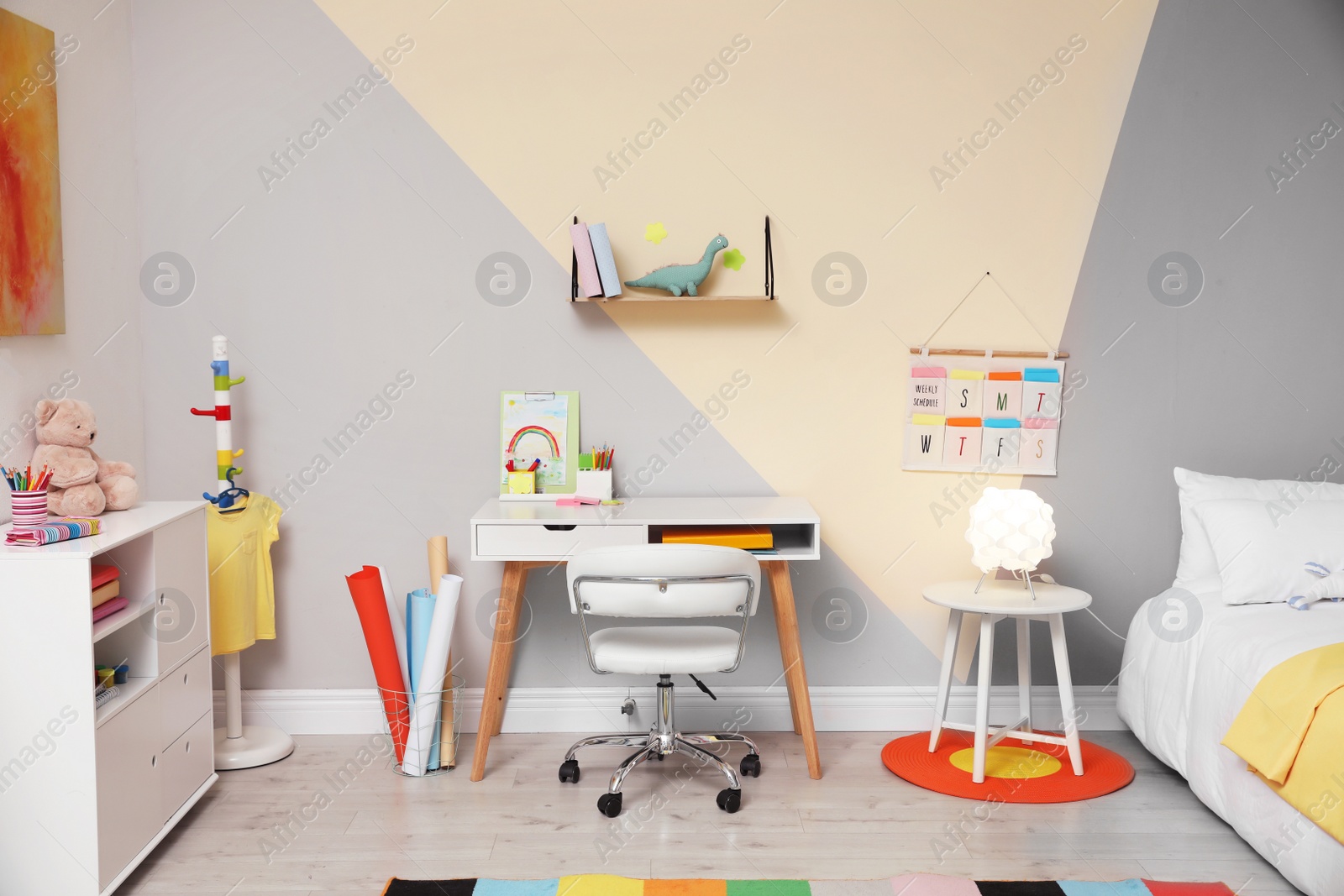 Photo of Stylish child room interior with comfortable bed and desk