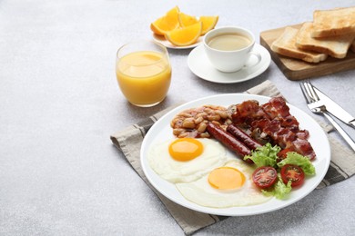 Photo of Delicious breakfast with sunny side up eggs on light table. Space for text
