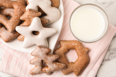 Photo of Sweet delicious cookies and glass of milk on napkin, top view