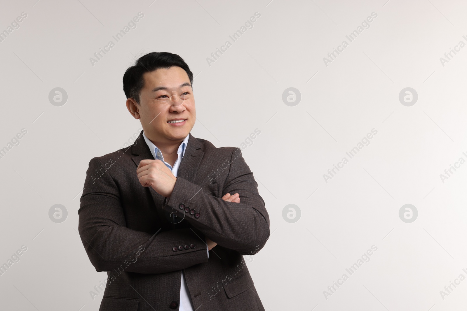 Photo of Portrait of happy man on light background. Space for text