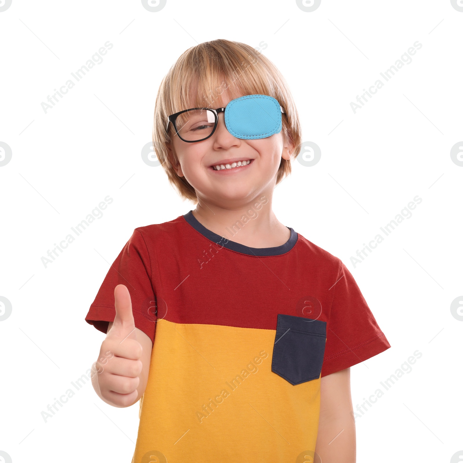 Photo of Happy boy with nozzle on glasses for treatment of strabismus showing thumbs up against white background