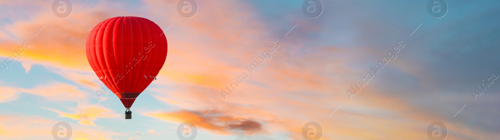 Image of Hot air balloon in sky with clouds, space for text. Banner design 