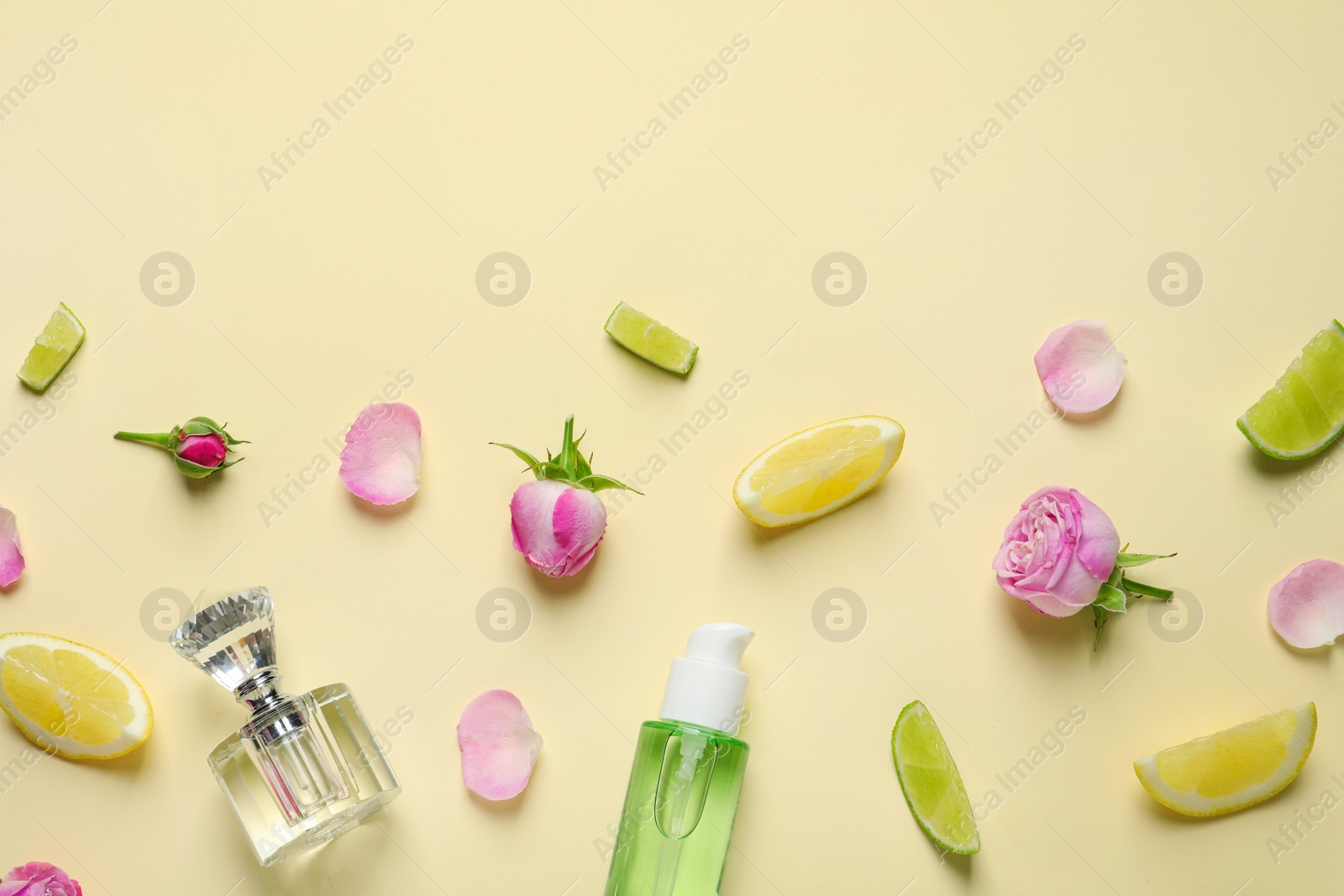 Photo of Flat lay composition with elegant perfume on beige background, space for text