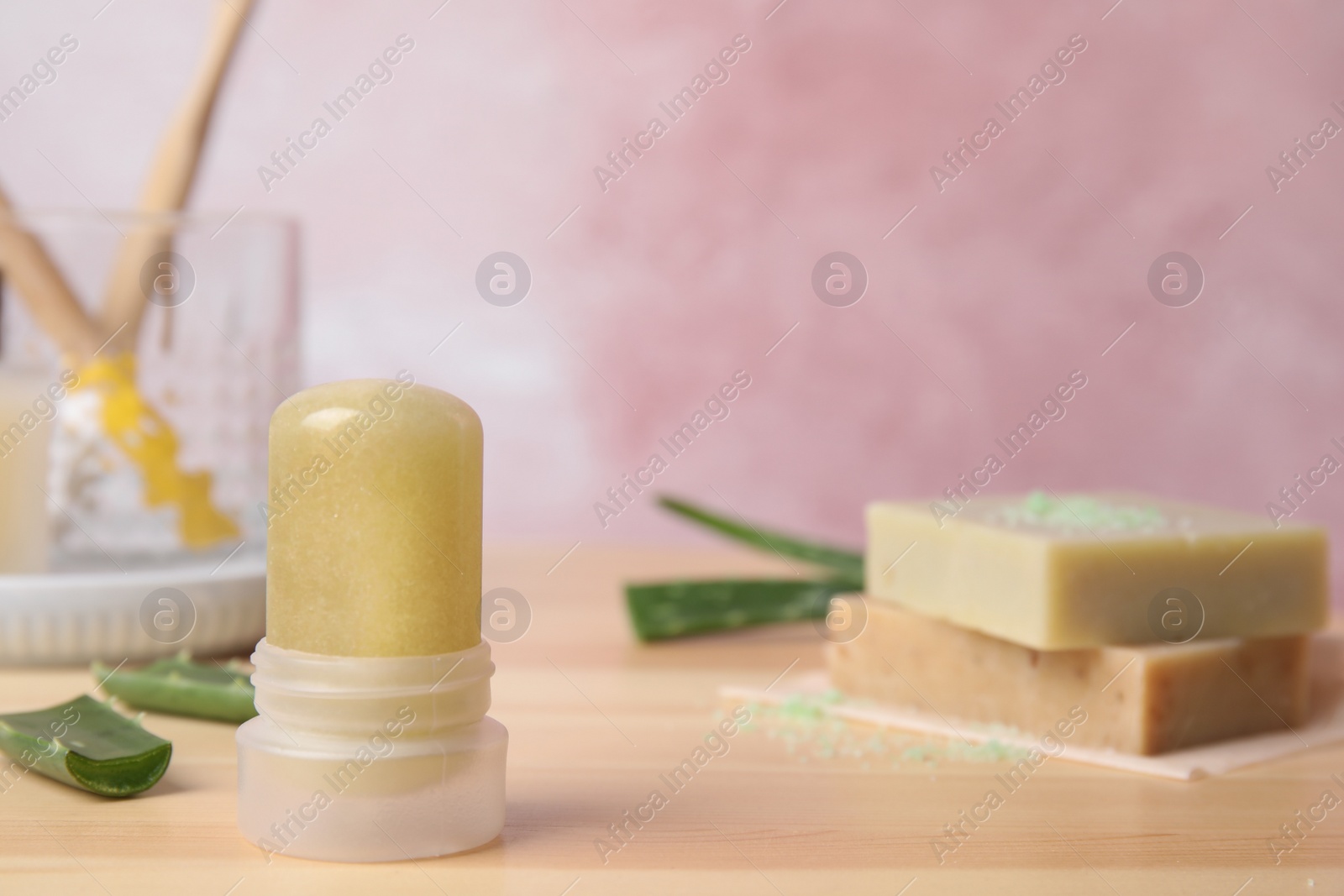 Photo of Natural crystal alum deodorant and aloe on wooden table