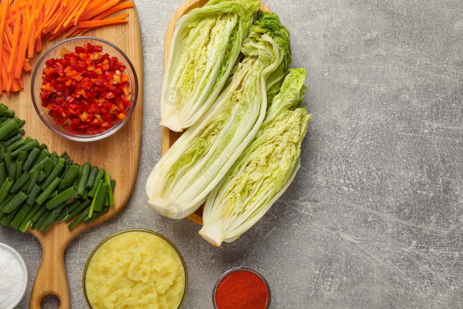 Photo of Fresh Chinese cabbages and other kimchi ingredients on light grey table, flat lay. Space for text