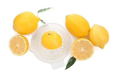 Photo of Glass squeezer and fresh lemons on white background, top view