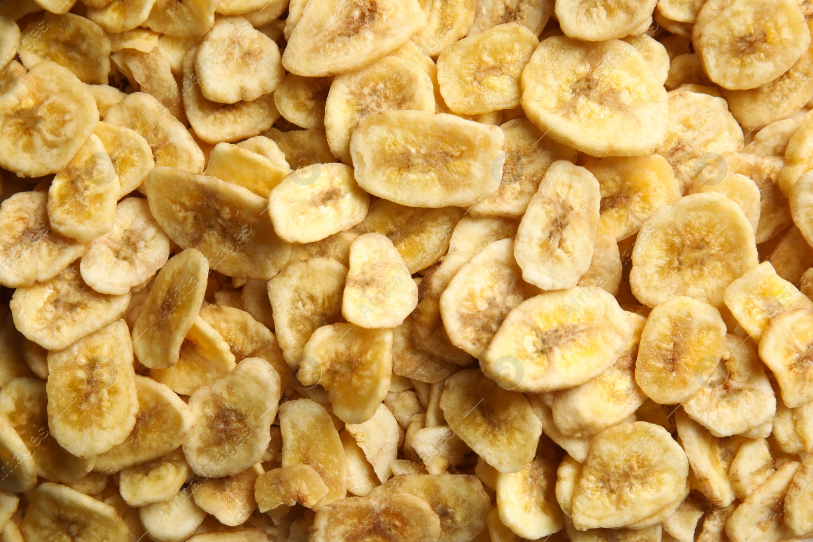 Photo of Sweet banana slices as background, top view. Dried fruit as healthy snack