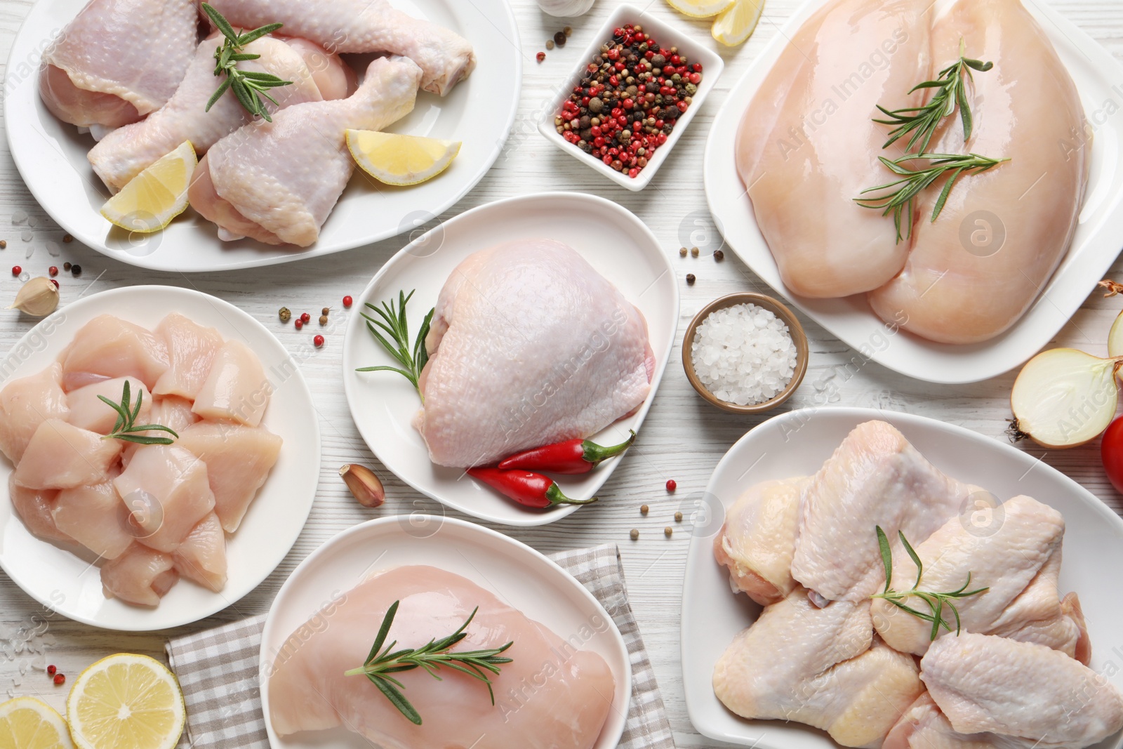 Photo of Flat lay composition with fresh raw chicken meat on white wooden table