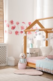 Stylish child room interior with wooden house bed