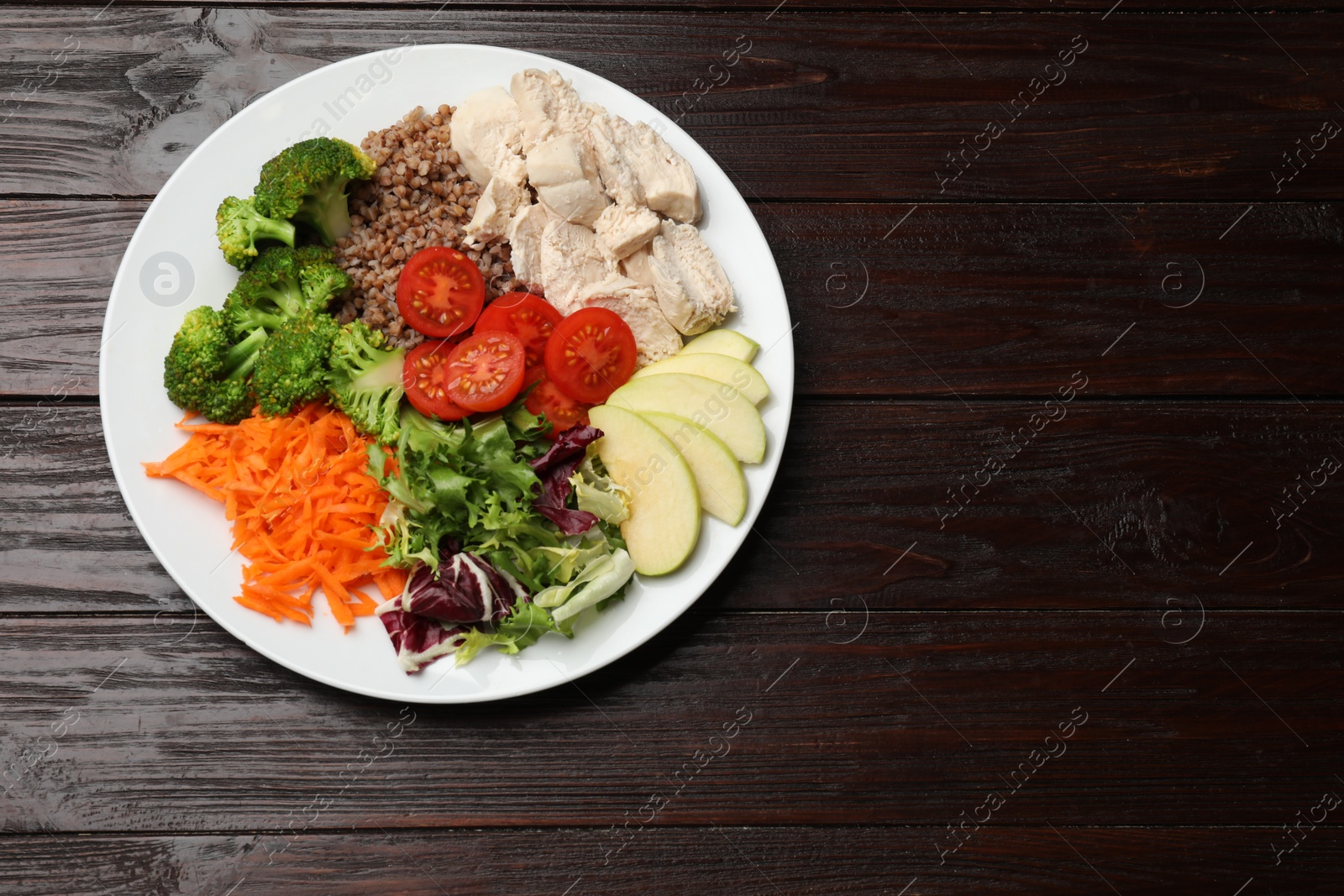 Photo of Balanced diet and healthy foods. Plate with different delicious products isolated on wooden table, top view. Space for text