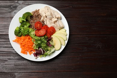 Photo of Balanced diet and healthy foods. Plate with different delicious products isolated on wooden table, top view. Space for text