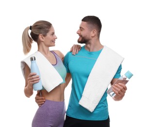 Photo of Athletic people with bottles of water and towels on white background